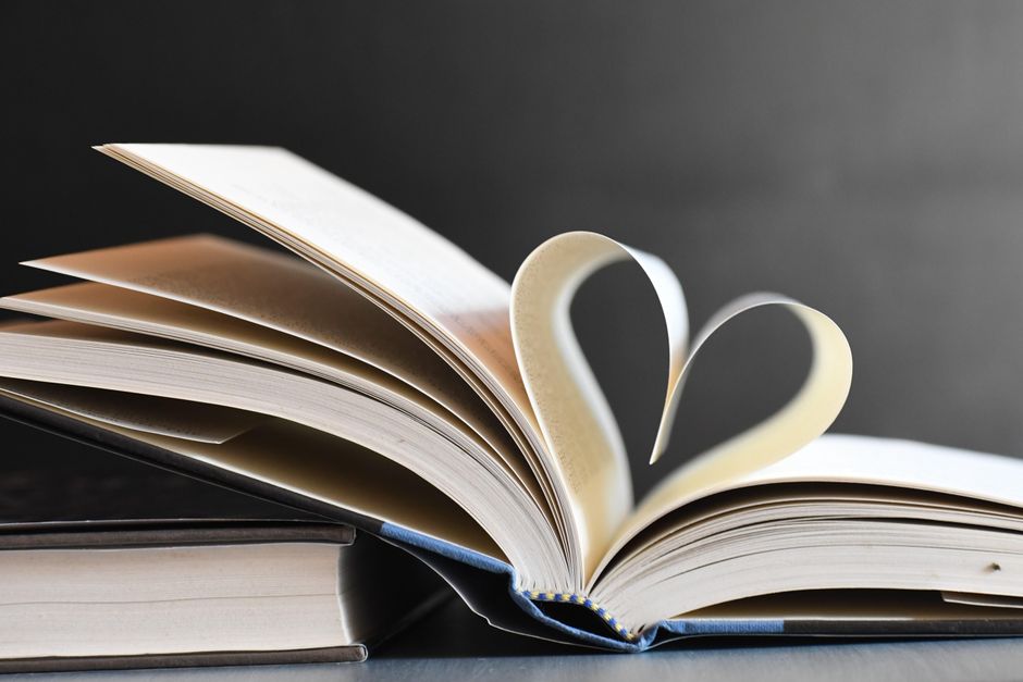 Open book with pages forming a heart, symbolizing love for reading and literature.